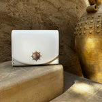 Sustainable KI'OLAL carry case crafted from cactus leather, displayed on golden-toned steps