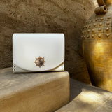 Sustainable KI'OLAL carry case crafted from cactus leather, displayed on golden-toned steps