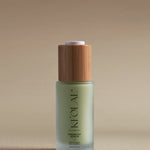 KI'OLAL Energizing Day Serum in green glass bottle with bamboo cap on neutral backdrop