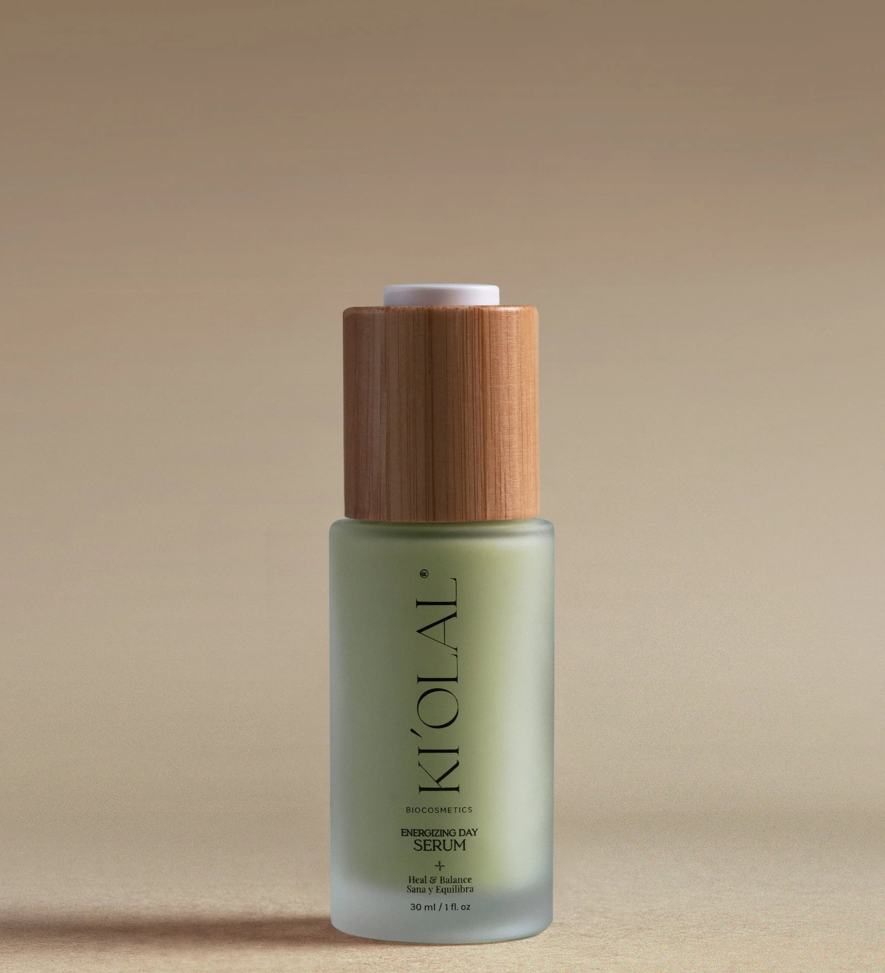KI'OLAL Energizing Day Serum in green glass bottle with bamboo cap on neutral backdrop