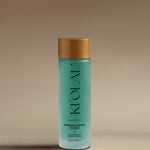 Close-up of KI'OLAL Toner bottle with bamboo cap, highlighting hydration