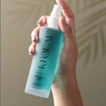 Close-up of KI'OLAL Mist bottle in use, emphasizing skincare ritual
