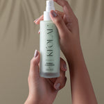 Hands holding KI'OLAL Cleanser bottle for daily skincare