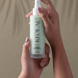 Hands holding KI'OLAL Cleanser bottle for daily skincare