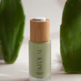 Close-up of KI'OLAL Day Serum with wooden cap and cactus paddles