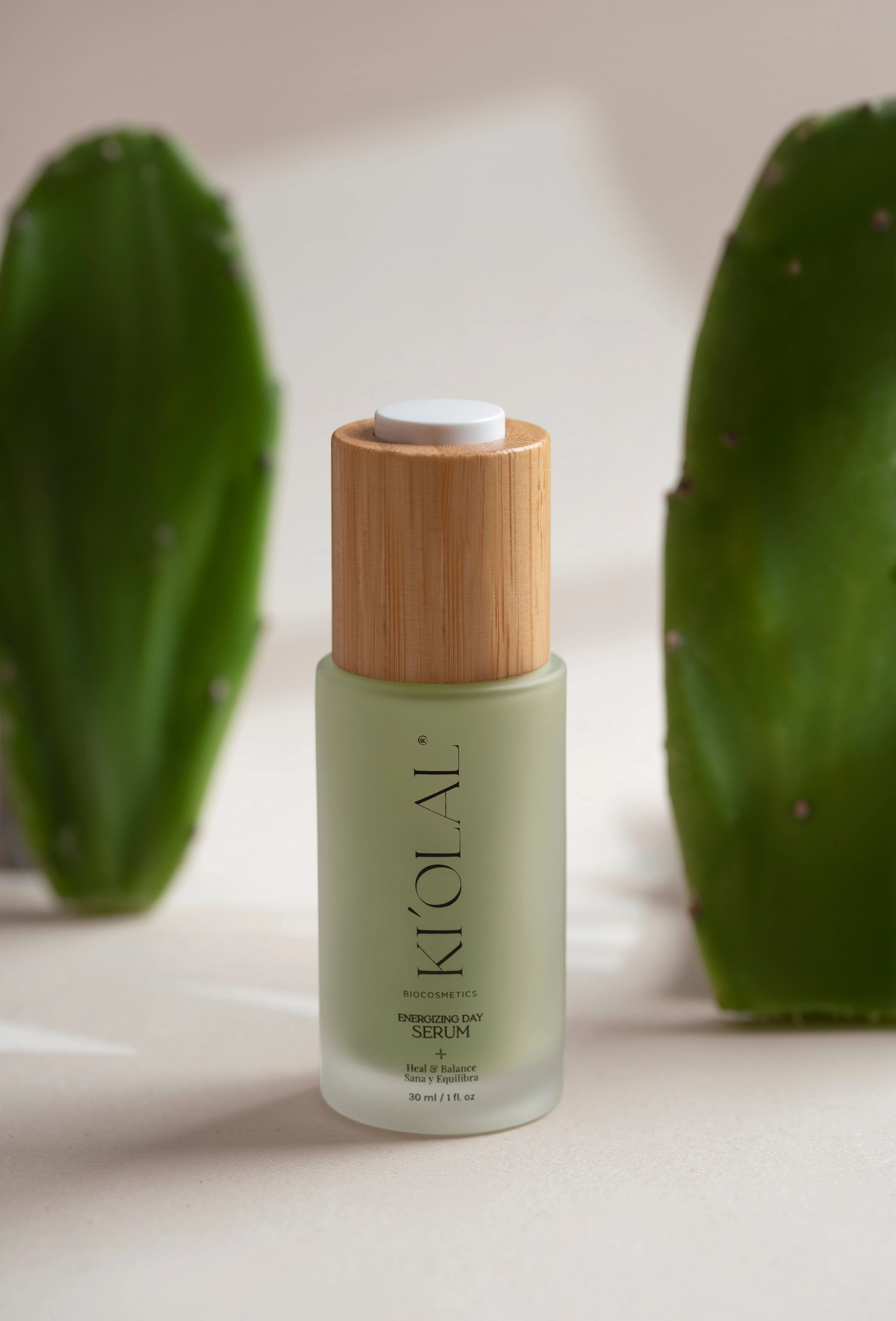 Close-up of KI'OLAL Day Serum with wooden cap and cactus paddles