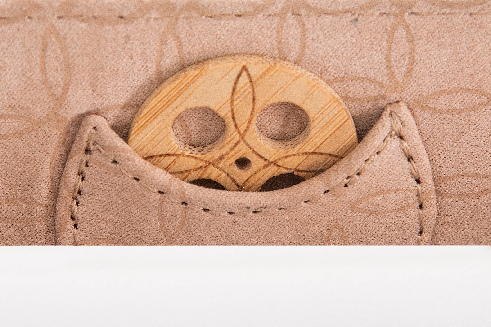 Close-up of KI'OLAL bamboo incense holder in stitched pocket