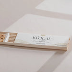 Soft focus on KI'OLAL products and sacred bag, daily skincare ritual