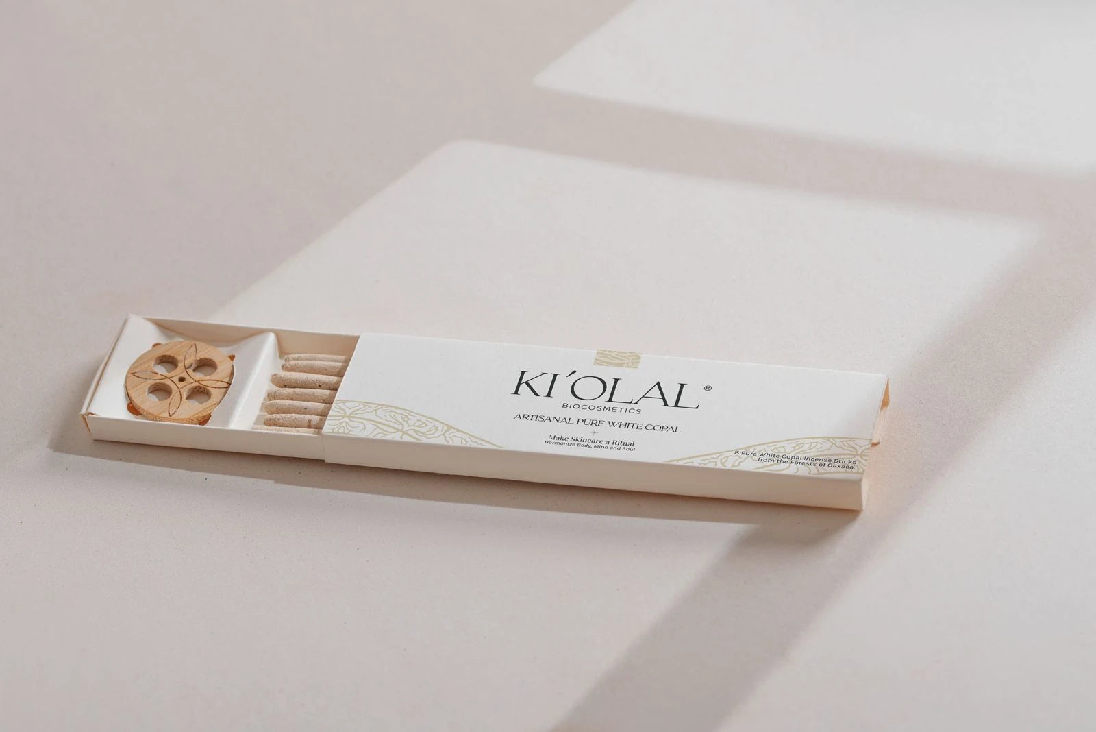 Soft focus on KI'OLAL products and sacred bag, daily skincare ritual